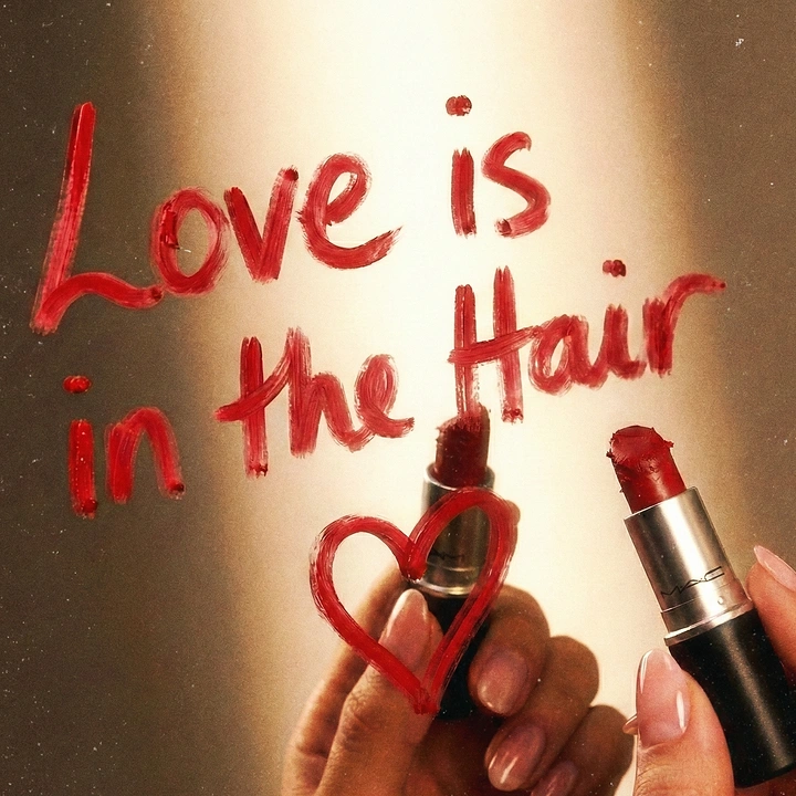 Valentine's Day creative ad: Hands writing a pun on a mirror with red lipstick