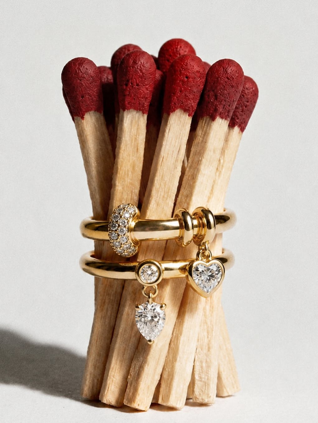 Valentine's Day Carousel: Bundle of red-tipped matches held by gold charm rings, slide 1