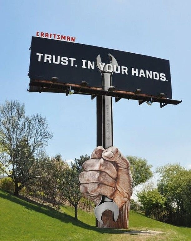 Power Tools creative ad: Giant hand creates trust metaphor