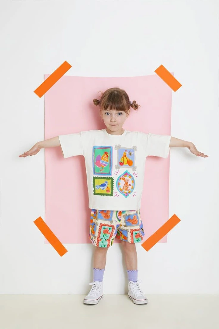 Kids Clothing creative ad: Child taped to wall like poster
