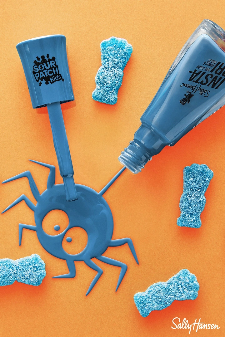 Halloween creative ad: Spilled blue nail polish forming a cartoon spider