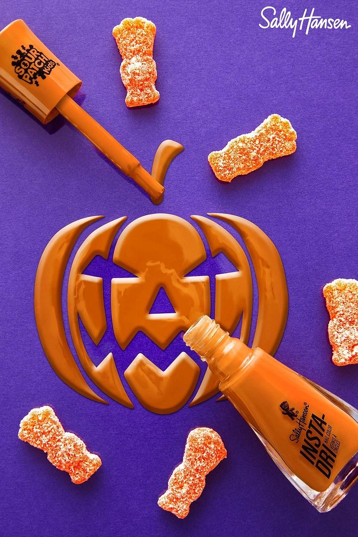 Halloween creative ad: Orange nail polish poured into a jack-o'-lantern shape