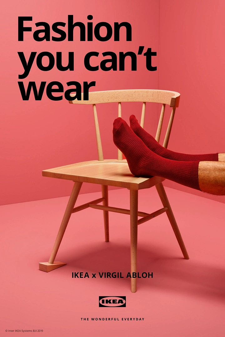 Home Decor creative ad: Wooden chair with a wedge under one leg and a pair of red-socked feet resting on the seat
