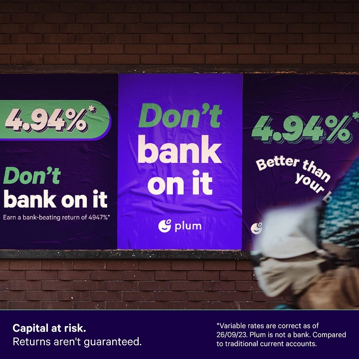 Stock Brokers & Investing creative ad: Purple wheatpaste posters on a brick wall with a blurred passerby