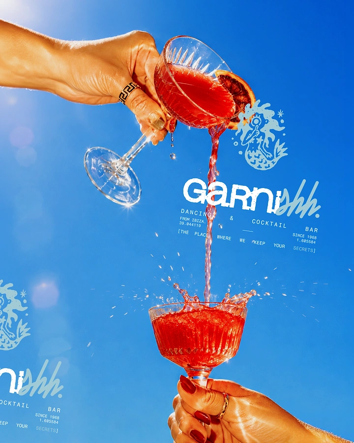Creative ad: Red cocktail poured from one coupe into another against a blue sky