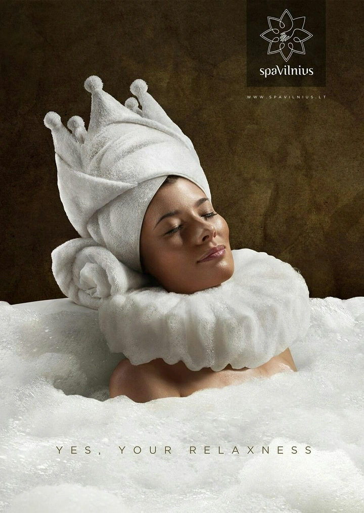 Spa & Massage creative ad: Woman in a bubble bath wearing a towel folded into a crown