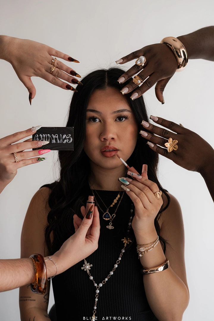 Nail Salons creative ad: Many hands framing model, campaign shot