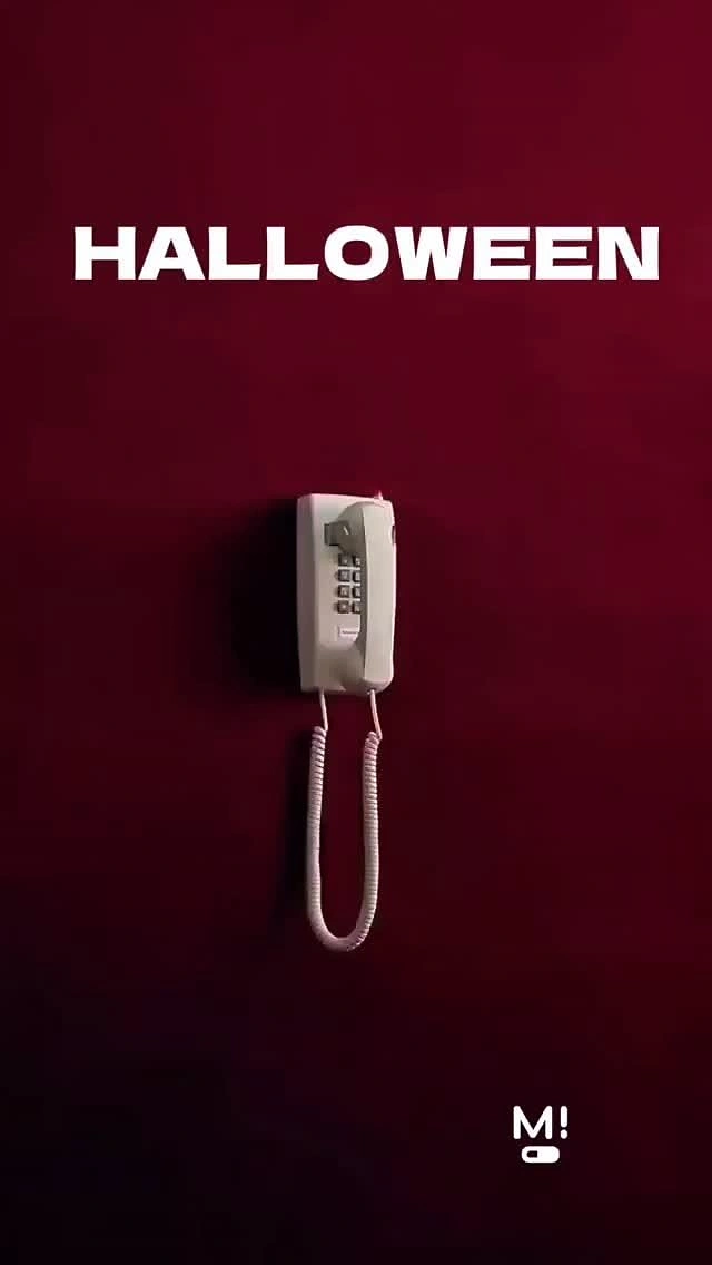 Halloween creative ad: Beige wall phone on dark red wall