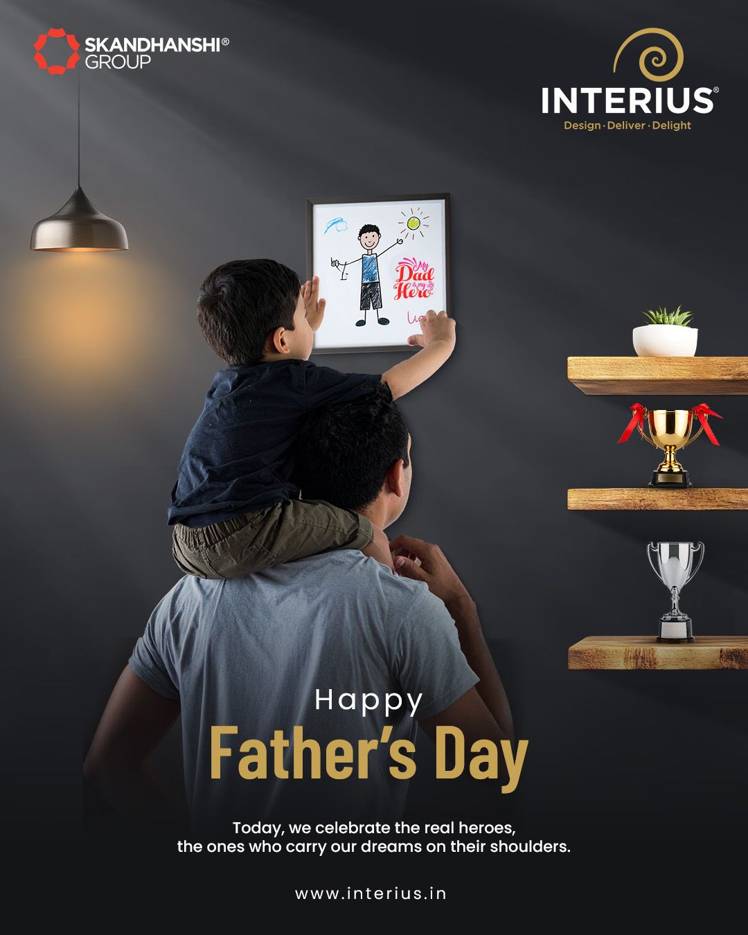 Child on father's shoulders hanging a 'My Dad is my Hero' drawing