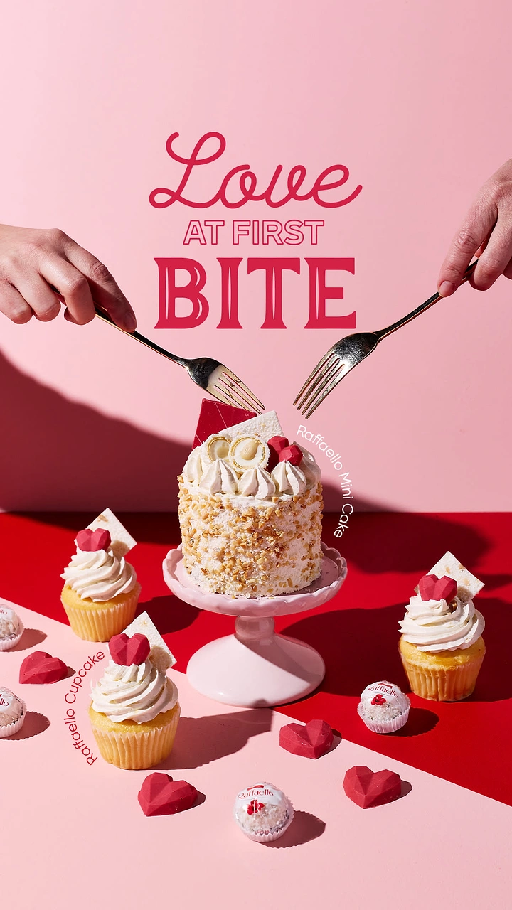 Valentine's Day creative ad: Mini cake on pink stand with two hands reaching in with forks