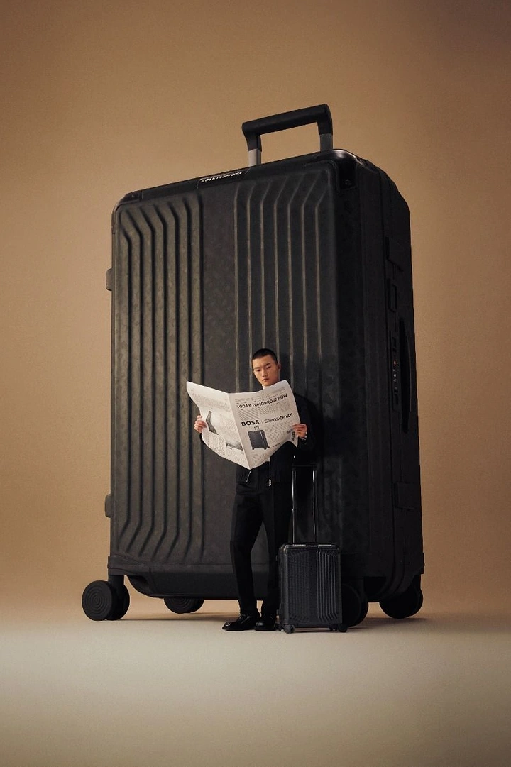 Luggage & Travel Bags creative ad: Tiny reader beside giant suitcase