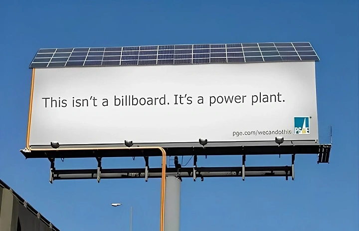 Solar & Energy creative ad: Billboard topped with solar panels against blue sky
