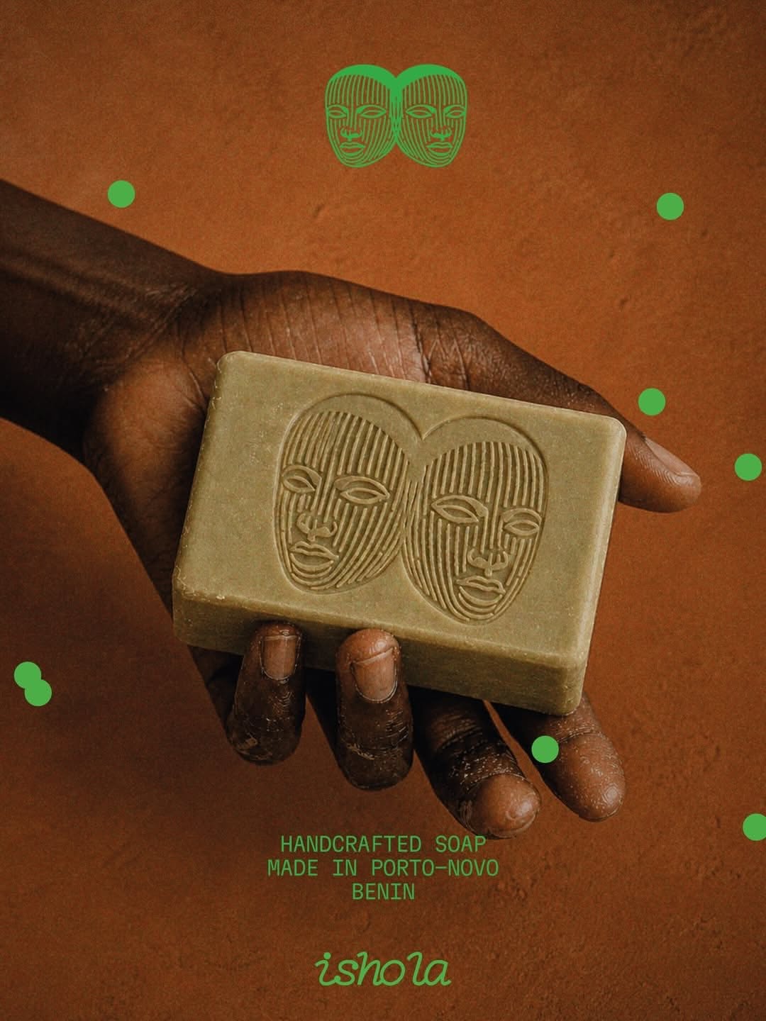 Instagram post: Dark-skinned hand presenting an olive-green soap bar embossed with twin faces