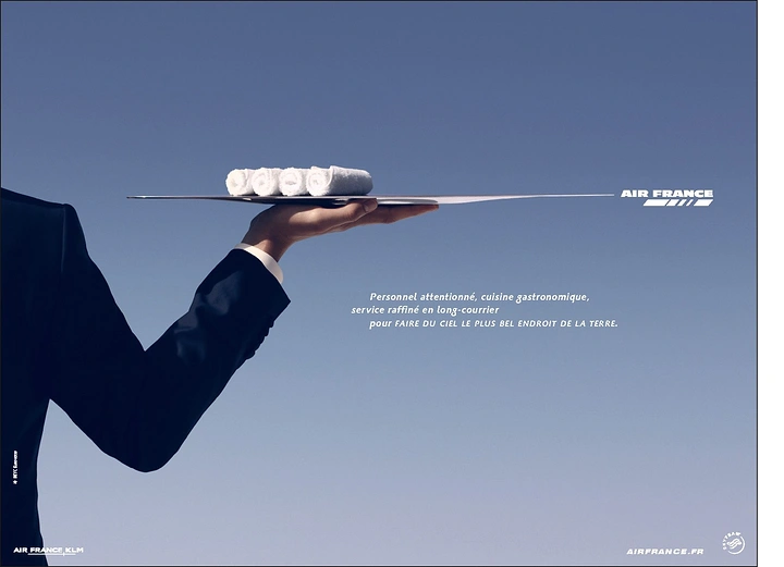 Creative ad: Waiter's suited arm holding a tray shaped like an aircraft wing