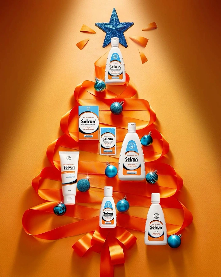 Christmas creative ad: Shampoo products arranged on a ribbon Christmas tree
