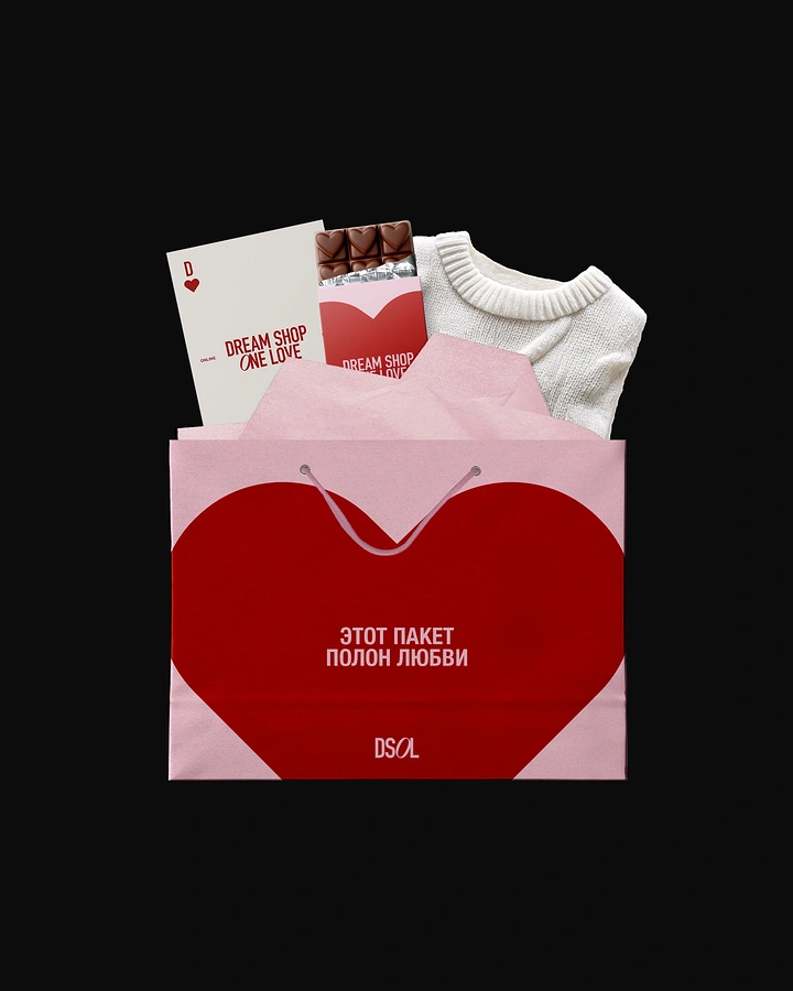 Valentine's Day creative ad: Pink shopping bag with a giant red heart, filled with a chocolate bar, a card and a sweater