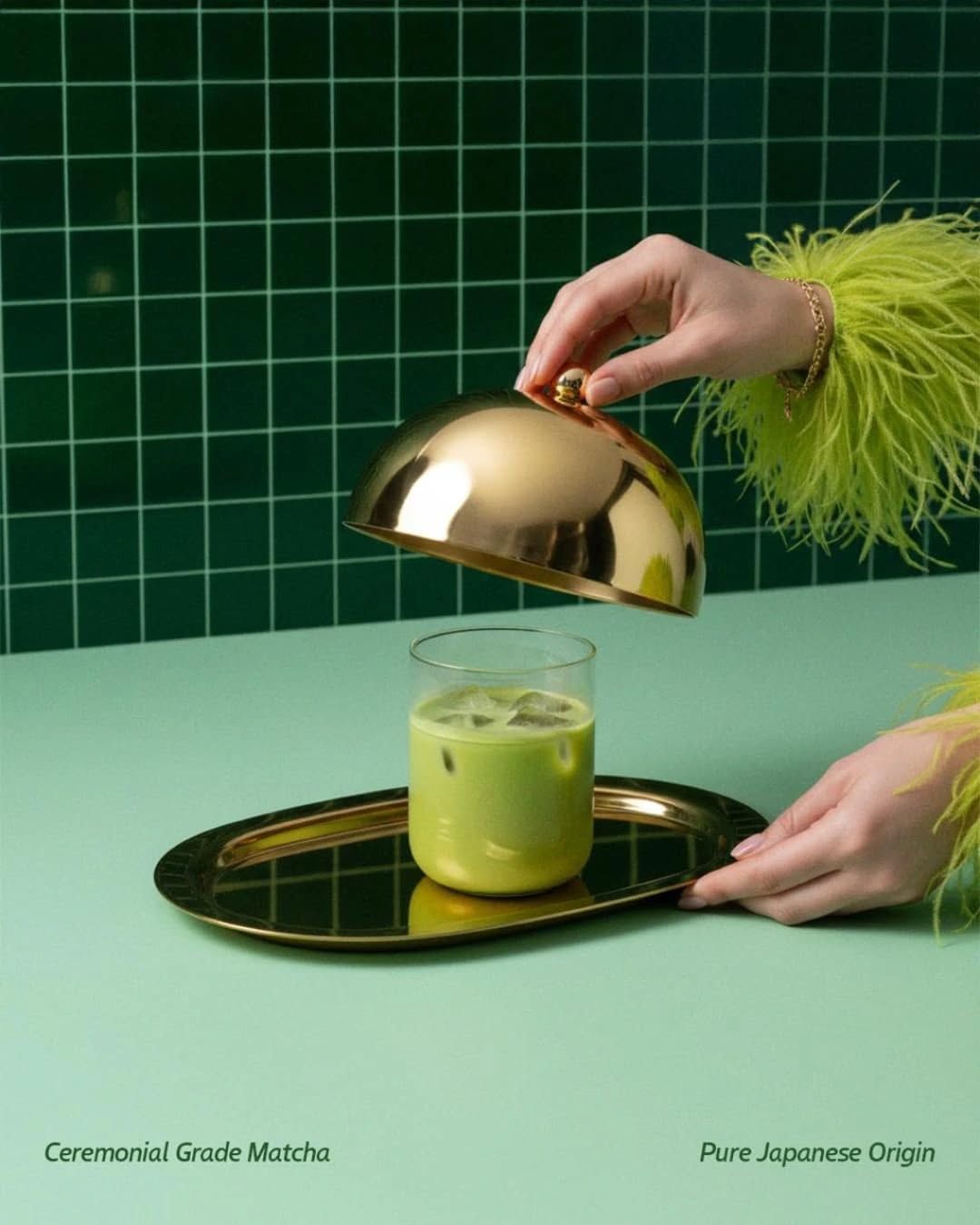 Instagram post: Hands lifting a gold cloche to reveal iced matcha