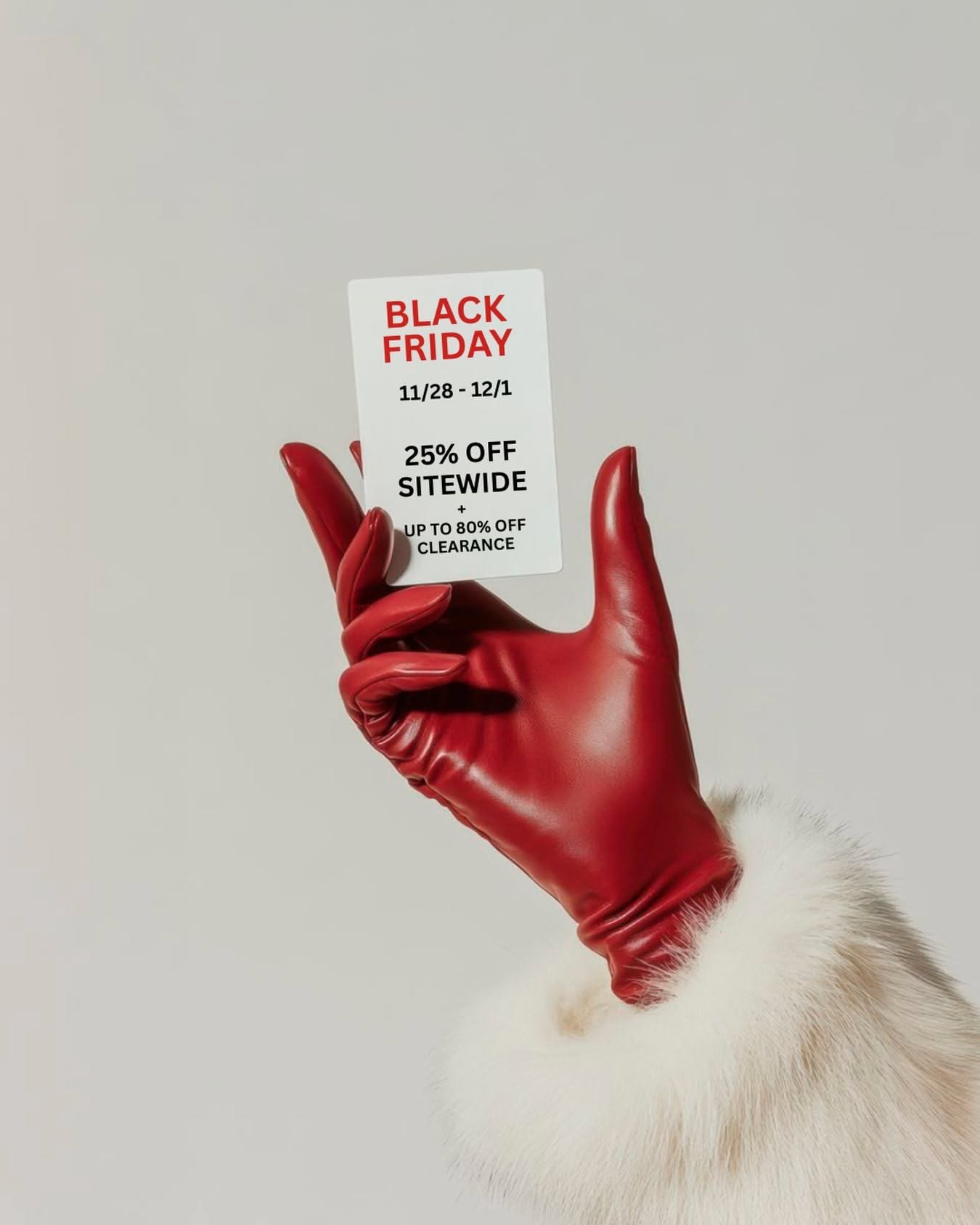 Red leather-gloved hand with fur cuff holding a sale card