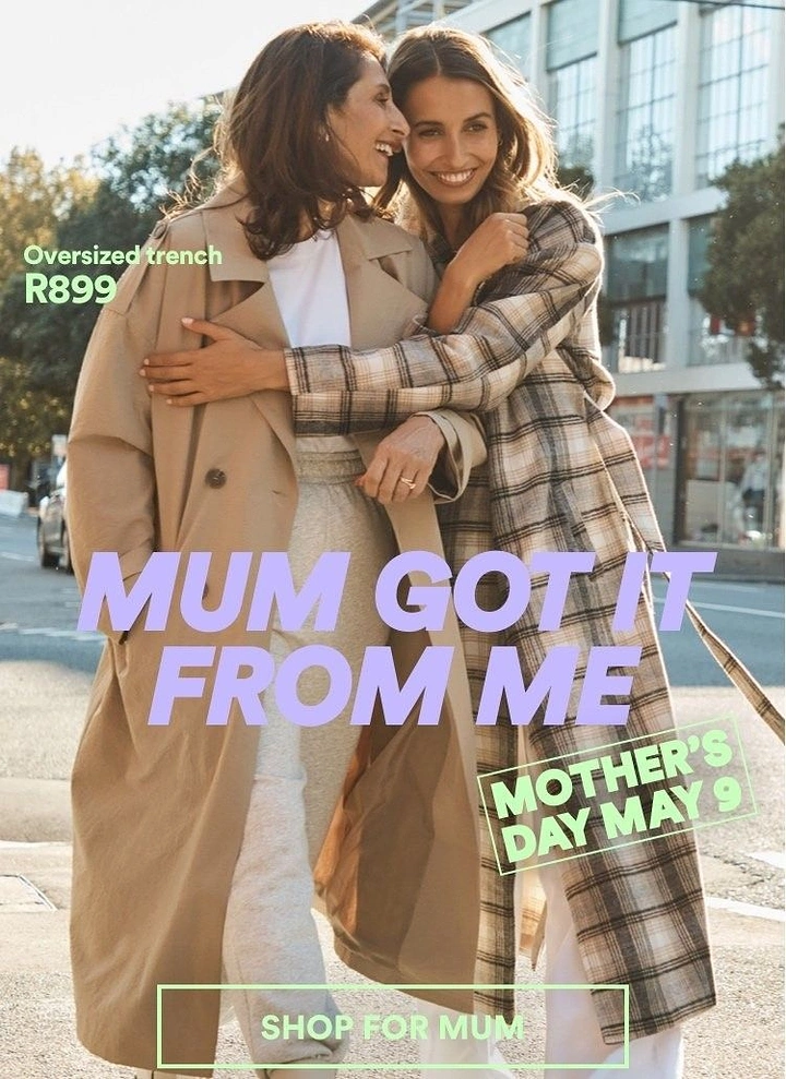 Mother's Day creative ad: Mother and daughter hugging on a sunny street in long coats