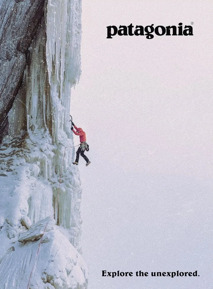 Outdoor & Camping Gear creative ad: Ice climber in red jacket on a frozen cliff face
