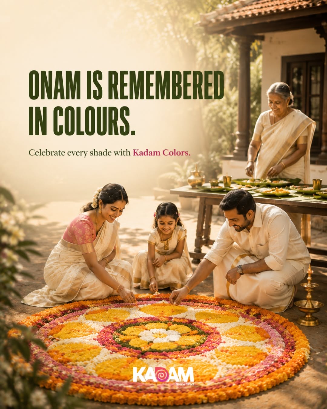 Flower pookalam beside a brass lamp and folded gold-bordered kasavu cloth