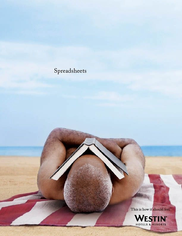 Travel creative ad: Man lying face-down on beach towel with open book tented over his head
