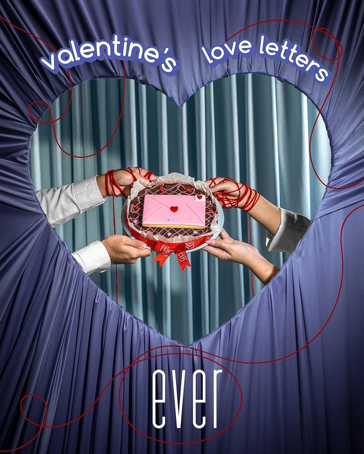 Valentine's Day creative ad: Hands holding a love-letter cookie cake through a heart-shaped drape