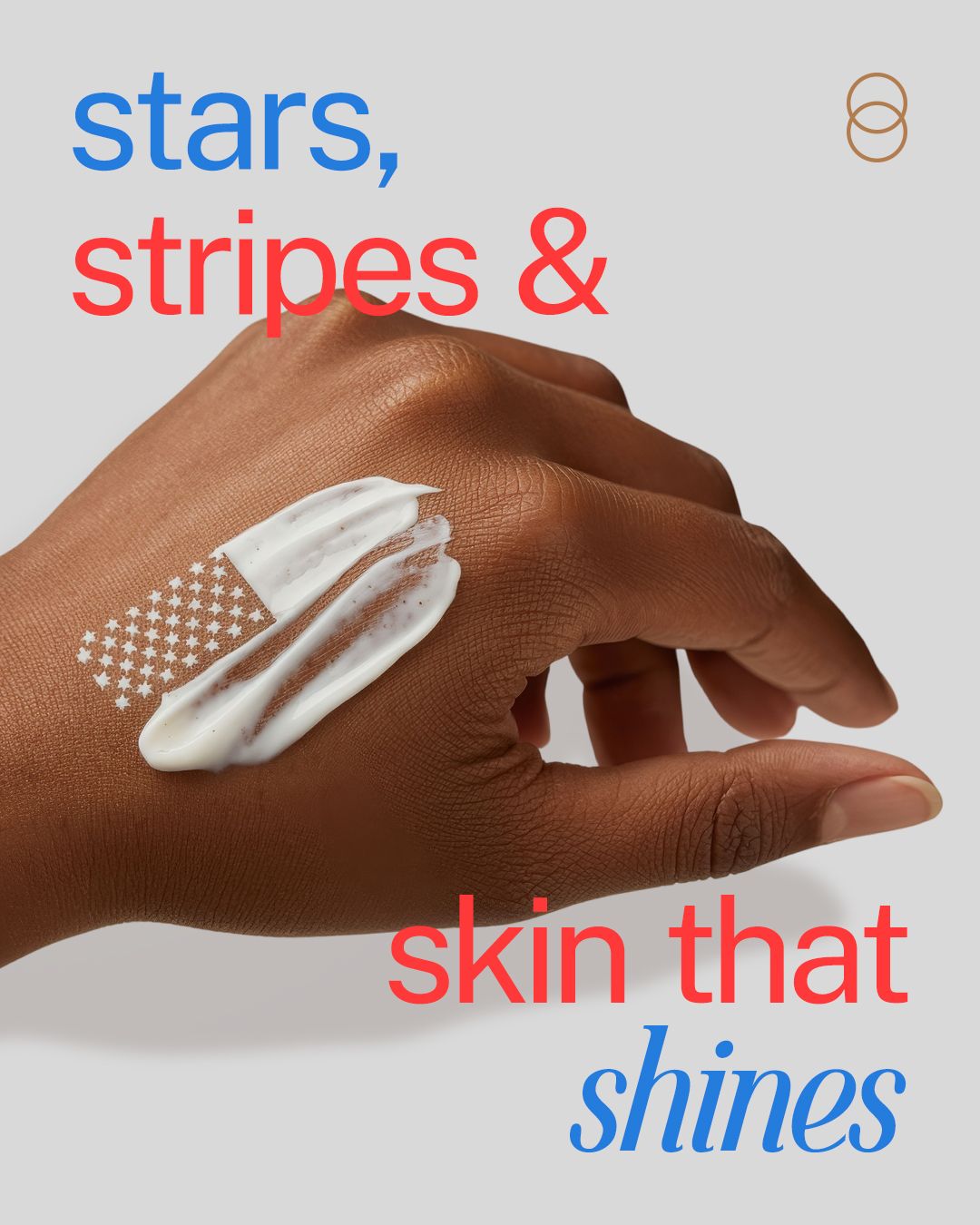 Hand with white lotion swatch shaped like the US flag