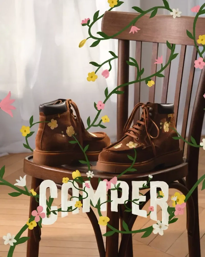 Creative ad: Brown suede boots with flower embroidery on a wooden chair, wrapped in illustrated vines