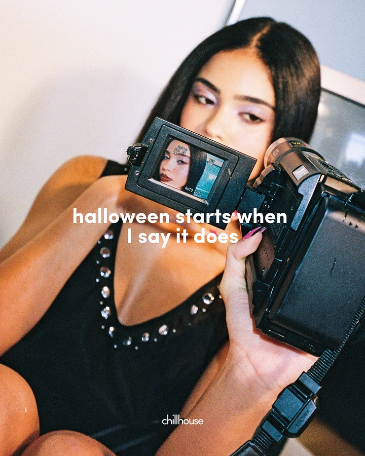 Halloween creative ad: Woman filming herself with a vintage camcorder
