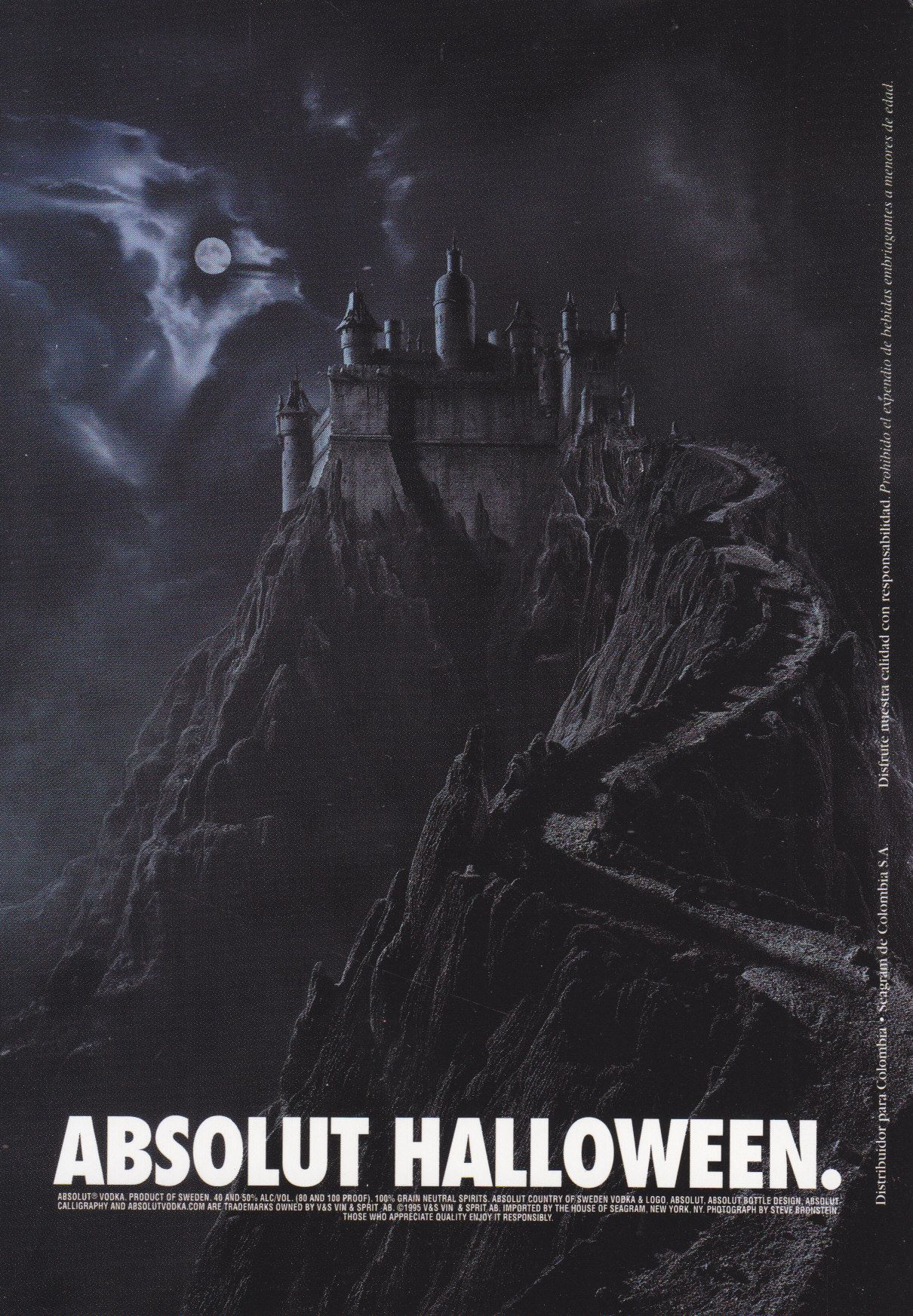 Gothic castle atop a jagged moonlit mountain with a winding road
