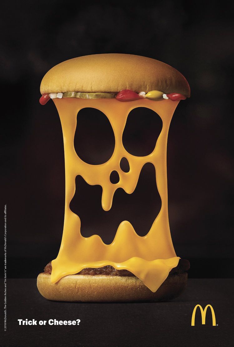 Cheeseburger with stretched melted cheese forming a screaming ghost face