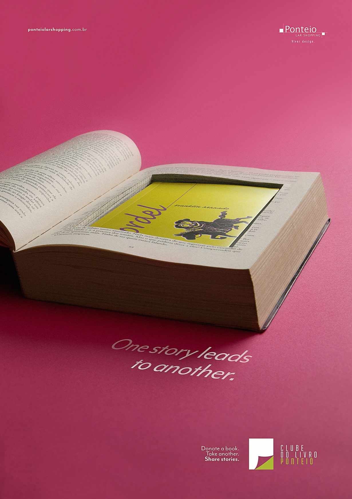 Open thick book with a hollowed cavity holding a yellow paperback
