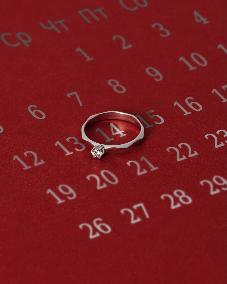 Valentine's Day Instagram post: Diamond solitaire ring encircling the date 14 on a red calendar