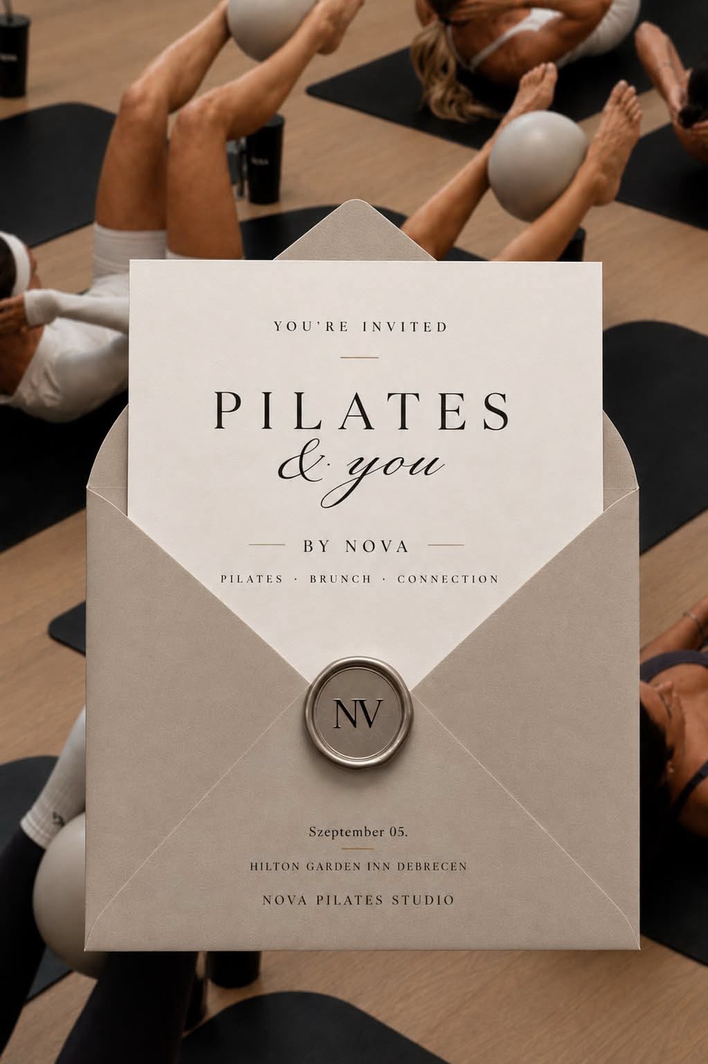 Instagram post: Greige envelope with card and wax seal over overhead pilates class