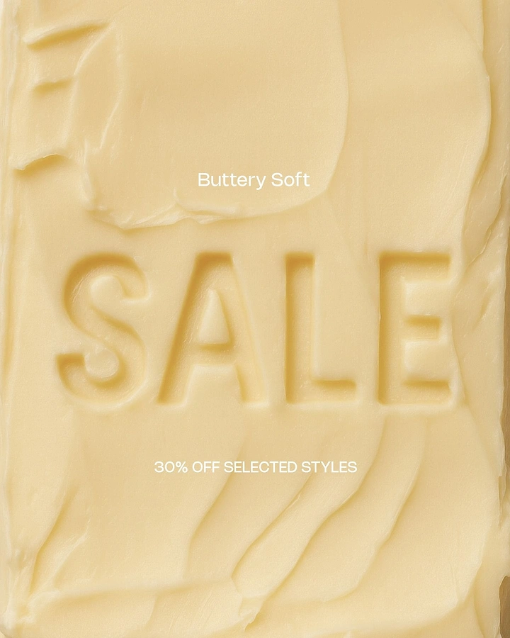 Creative ad: Macro shot of a butter block with the word sale embossed into it
