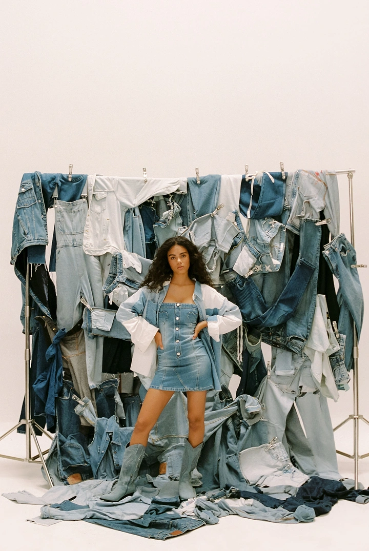 Denim & Jeans Brands creative ad: Model surrounded by denim installation