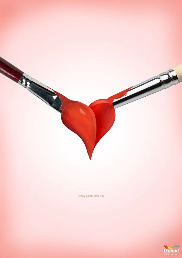 Valentine's Day creative ad: Two paintbrushes meeting to form a red paint heart