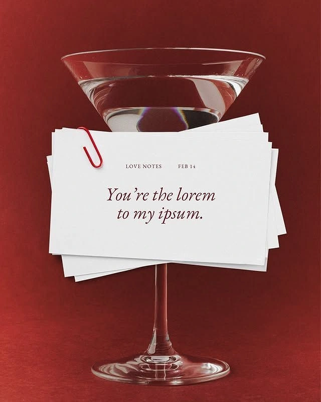 Valentine's Day creative ad: Martini glass with stack of love-note cards