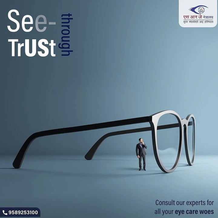 Creative ad: Tiny businessman standing beside giant black-and-silver eyeglasses