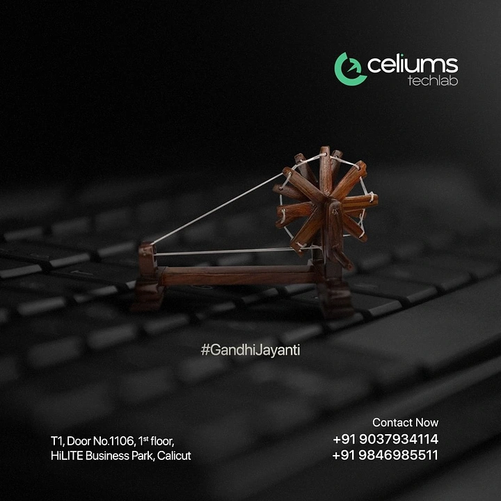 Gandhi Jayanti creative ad: Miniature wooden charkha on a laptop keyboard