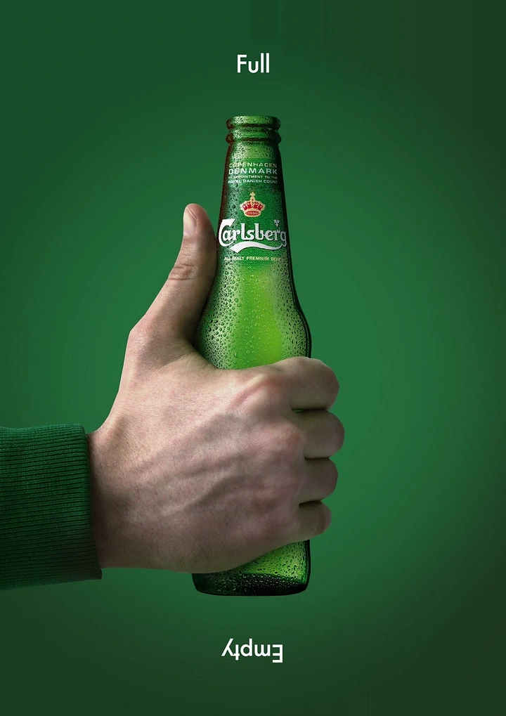 Creative ad: Hand in green sleeve gripping a dewy green beer bottle as a thumbs-up