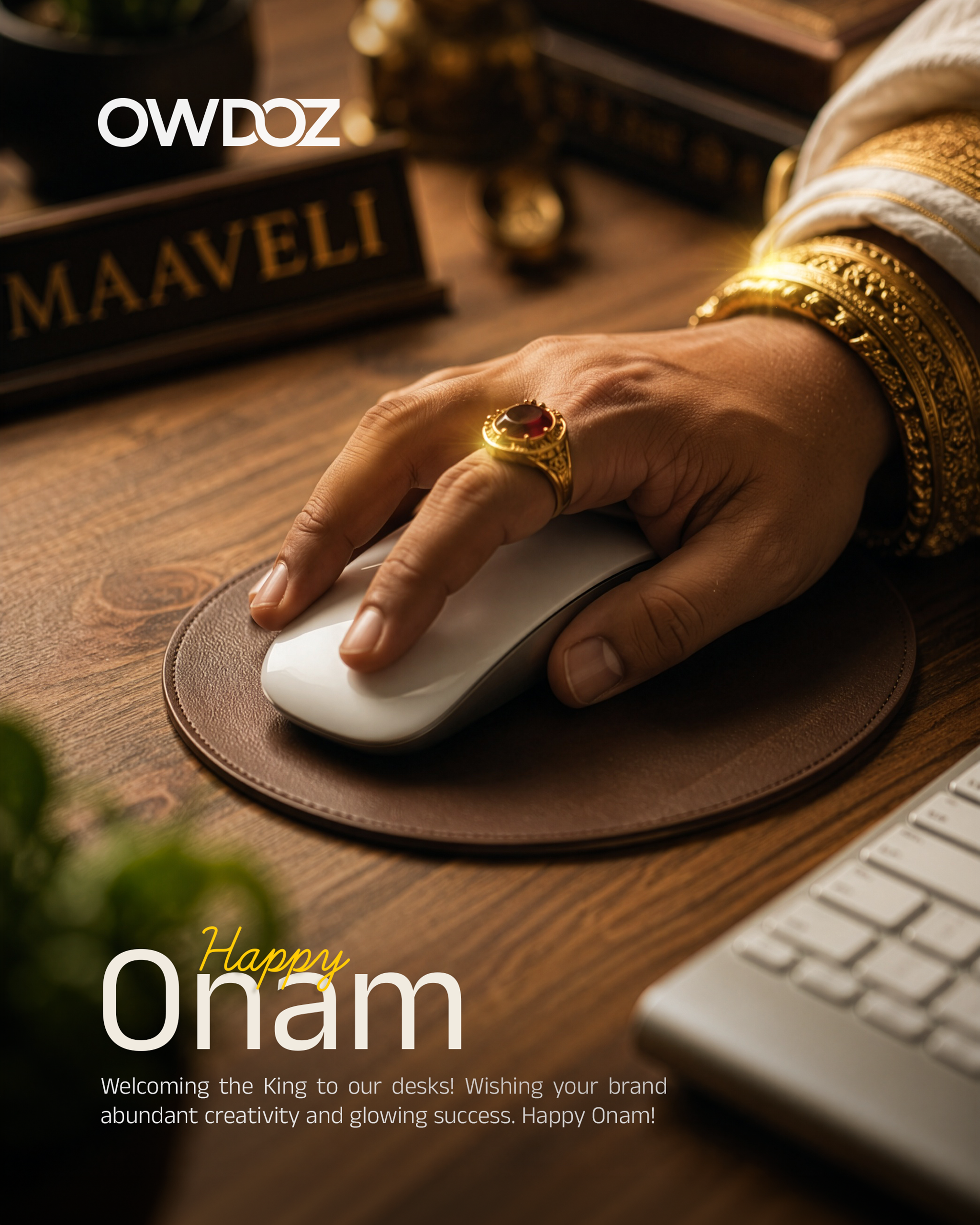 King Maveli's jewelled hand using a computer mouse on an office desk