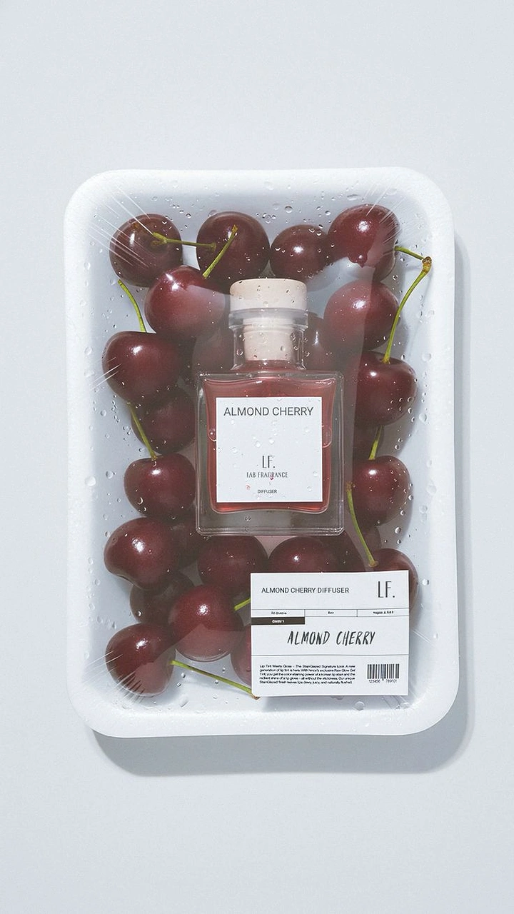 Home Decor creative ad: Diffuser bottle packed with cherries in a cling-wrapped grocery tray
