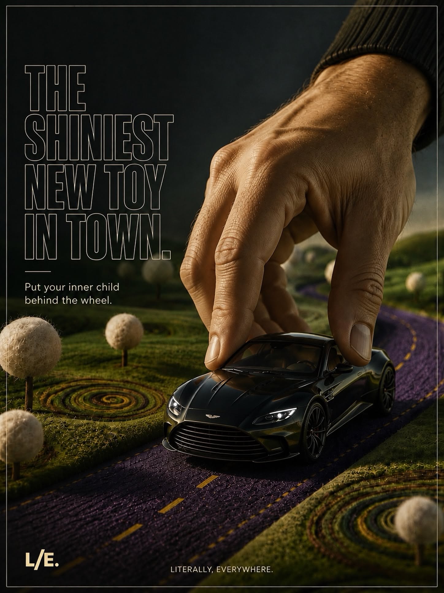 Instagram post: Giant hand pushing a black sports car like a toy on a felt road