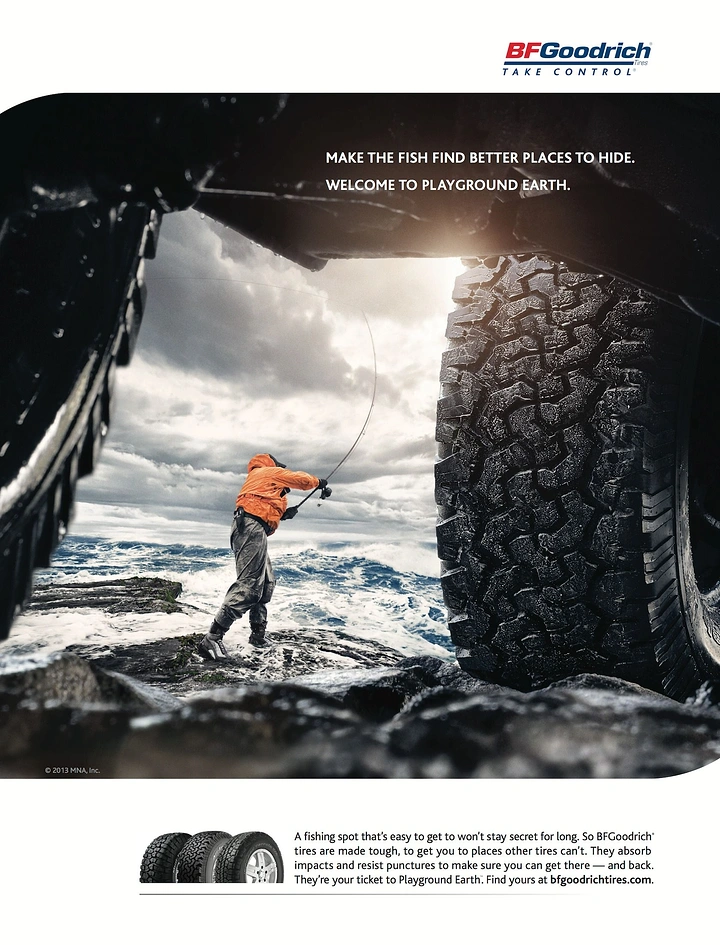 Outdoor & Camping Gear creative ad: Angler casting on stormy rocks, framed from beneath a truck between its knobby tyres