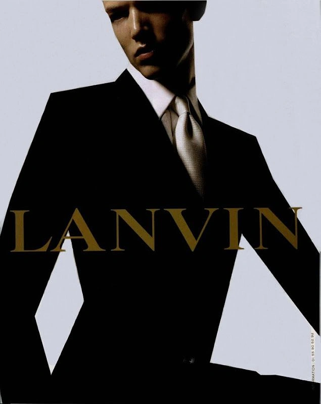 Fashion creative ad: Cropped male model in a black tailored suit