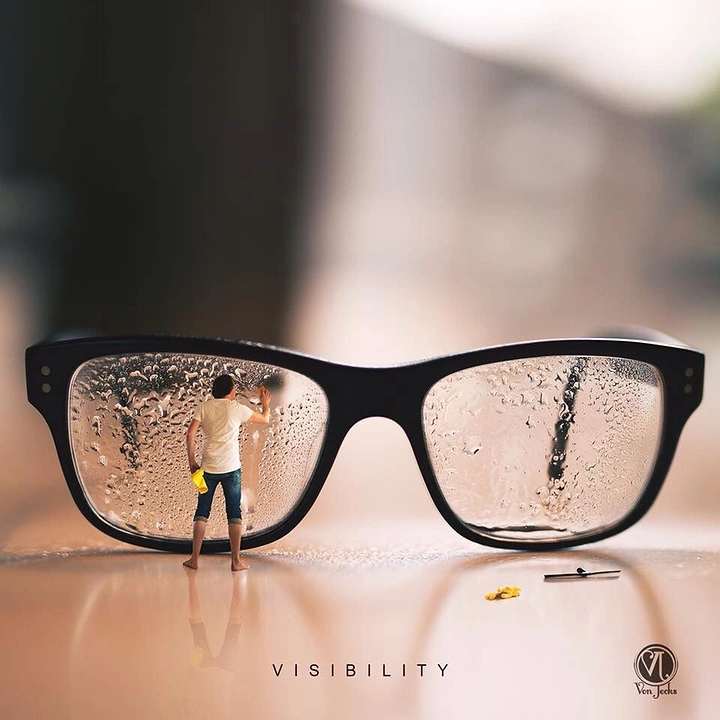 Opticians & Eye Care creative ad: Tiny man wiping giant foggy lenses