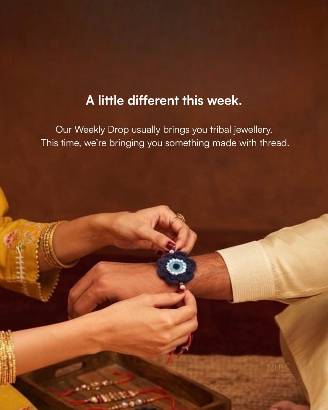 Sister tying crochet evil-eye rakhi on brother's wrist