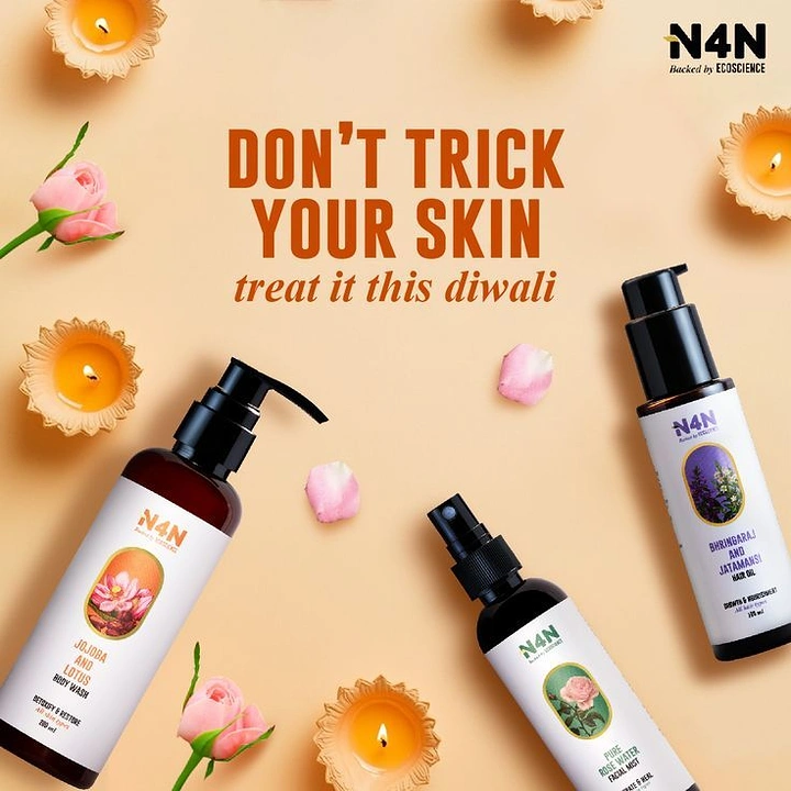 Diwali creative ad: Flatlay of three botanical personal-care bottles with lit diyas and roses